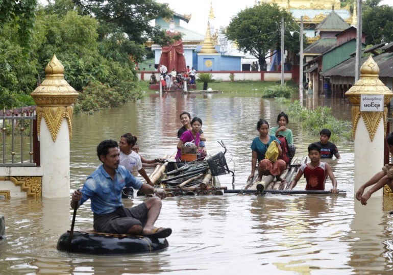 epa11603217 Flood victims wade through the flood with makeshift rafts in Taungoo, Bago division, Myanmar, 14 September 2024. Heavy rains triggered by Typhoon Yagi have caused severe flooding in parts of Myanmar, leaving thousands stranded in their homes, with further heavy rainfall and thunderstorms expected, according to the state weather office. A statement from the Military announced 59,413 households were affected in 34 townships and set up 187 relief camps for the 236,649 people. There were 33 casualties due to the flood in the country including the Naypyitaw. EPA-EFE/NYEIN CHAN NAING