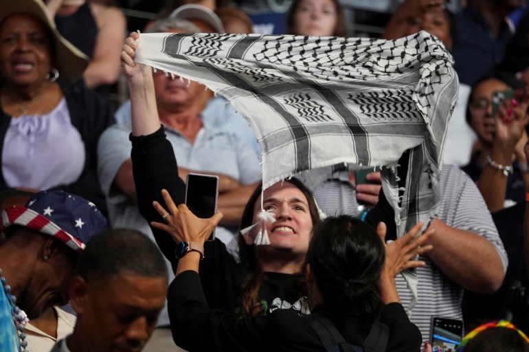 A demonstrator holds up a keffiyeh at Kamala Harris's Savannah rally