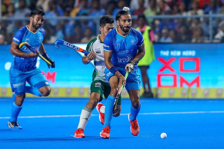 India's Akashdeep Singh, right, takes control of the ball during the men's Asian Champions Trophy hockey match between India and Pakistan in Chennai, India, Wednesday, Aug. 9, 2023. (AP Photo/R. Parthibhan)