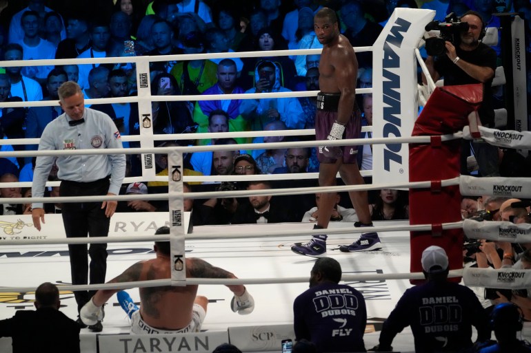 Ukraine's Oleksandr Usyk after he received a low blow from Britain's Daniel Dubois during their world heavyweight title fight at Tarczynski Arena in Wroclaw, Poland, Sunday, Aug. 27, 2023. Oleksandr Usyk defends his WBC, IBF and WBA heavyweight titles for the first time in a year when he faces hard-hitting British challenger Daniel Dubois in a clash of styles. (AP Photo/Czarek Sokolowski)