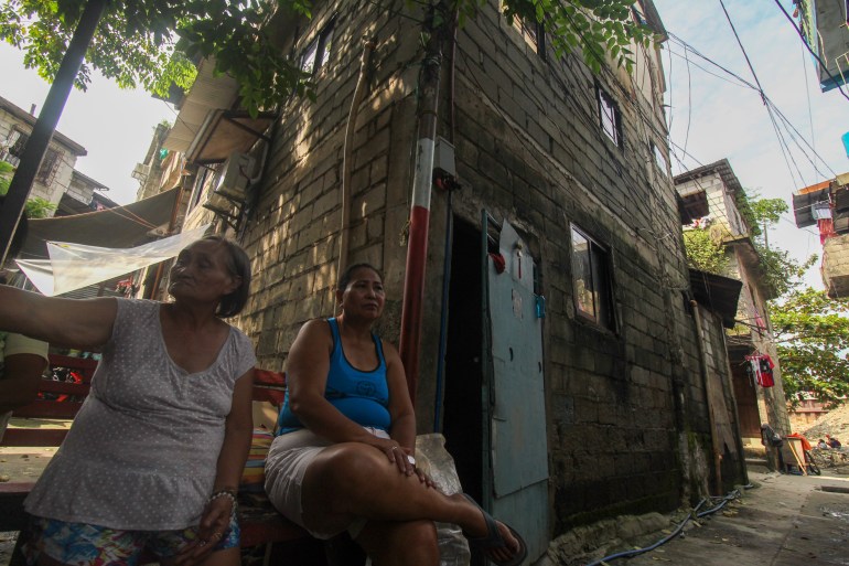 Castillo outside her home The walls on the lower floors of the three storey home are darker because of flooding 