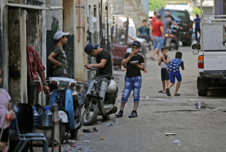 A boy sits atop a scooter along an alley in the Bab al-Tabbaneh, Tripoli.