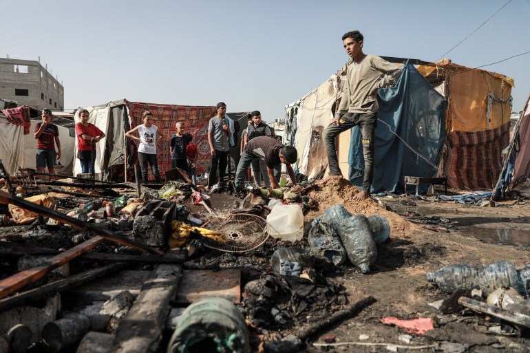 Displaced people are forced to scrabble through the charred remains of their flimsy tent homes to see what they can rescue to keep the family going a little longer. On October 14, 2024 