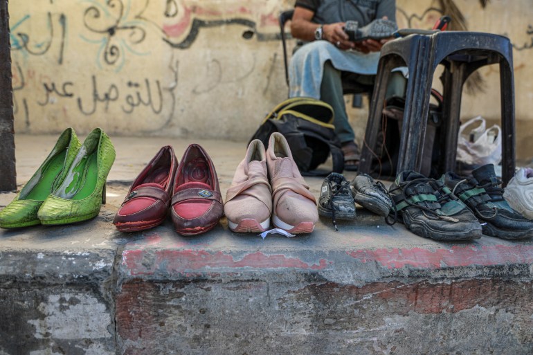 View of shoes lined up for mending near a cobbler or "iskafi" in the market in Deir el-Balah, Gaza