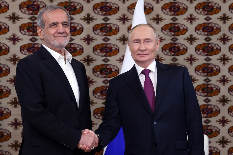 Russian President Vladimir Putin, right, and Iranian President Masoud Pezeshkian pose for a photo during their meeting on the sidelines of the International Forum "The Interconnection of Times and Civilizations – the basis of peace and development" dedicated to the 300th anniversary of the birth of the outstanding Turkmen poet and thinker Magtymguly Fragi in Ashgabat,