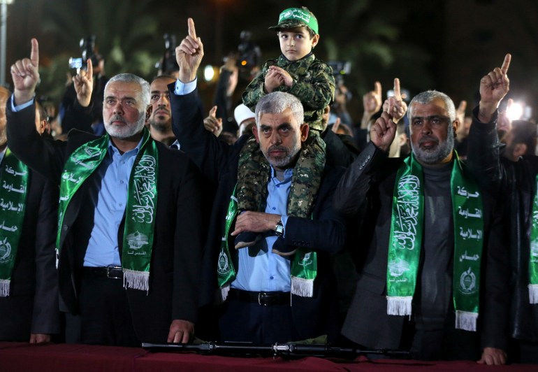 The son of senior Hamas militant Mazen Fuqaha sits on the shoulders of Hamas Gaza Chief Yehya Al-Sinwar during a memorial service for Fuqaha, in Gaza City March 27, 2017. REUTERS/Mohammed Salem TPX IMAGES OF THE DAY