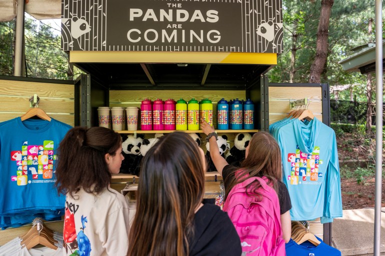 Visitors look at souvenirs after China's ambassador to the United States Xie Feng spoke to the media as he and staff members from The National Zoo and Conservation Biology Institute (NZCBI) announced that China will send two young giant pandas to the United States, during an update on the future of the giant panda conservation program at Smithsonian’s National Zoo in Washington, U.S., May 29, 2024. REUTERS/Ken Cedeno