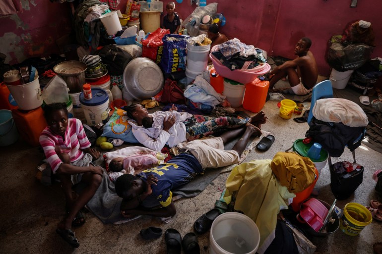 People displaced by gang war violence live inside a classroom at Darius Denis school, which transformed into a shelter where people live in poor conditions, in Port-au-Prince, Haiti May 5, 2024. Nearly half of the country’s population is struggling to feed themselves due to the conflict, unable to work, the families depend on food rations and hygiene kits brought in by non-governmental organizations