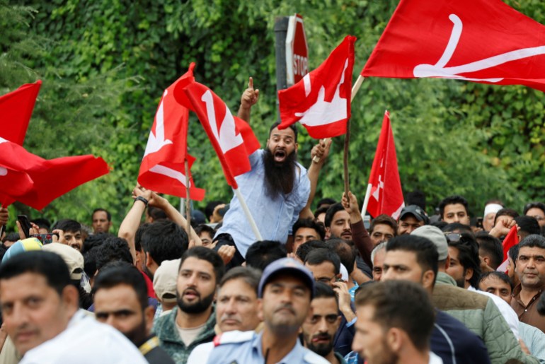 Supporters of the Jammu and Kashmir National Conference party shout slogans as they celebrate outside the vote counting centre on the day of the assembly election results, in Srinagar, October 08, 2024