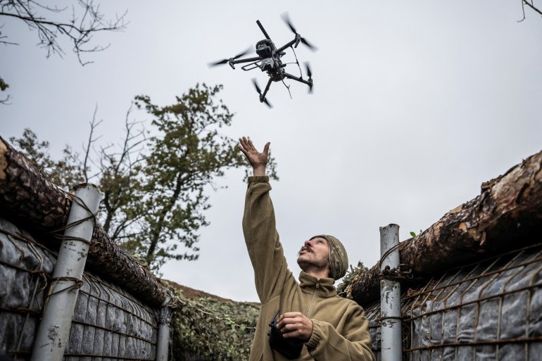 A serviceman of Da Vinci Wolves Separate Mechanized Battalion, named after Dmytro Kotsiubailo, of the 59th mechanized brigade of the Ukrainian Armed Forces, launches a combat drone at his frontline position, amid Russia's attack on Ukraine, near the town of Pokrovsk in Donetsk region, Ukraine October 20, 2024. REUTERS/Viacheslav Ratynskyi TPX IMAGES OF THE DAY