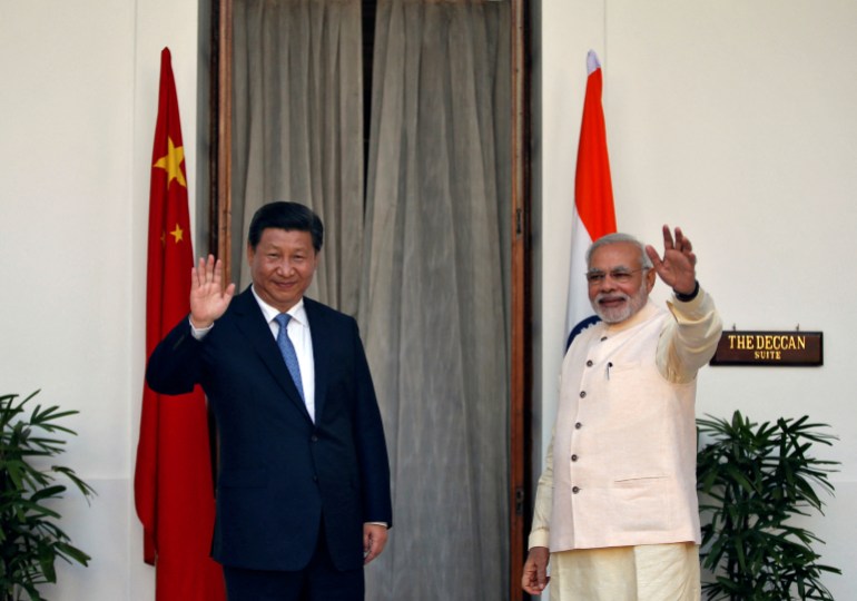 FILE PHOTO: India's Prime Minister Narendra Modi (R) and China's President Xi Jinping wave to the media during a photo opportunity ahead of their meeting at Hyderabad House in New Delhi, September 18, 2014. REUTERS/Ahmad Masood/File Photo