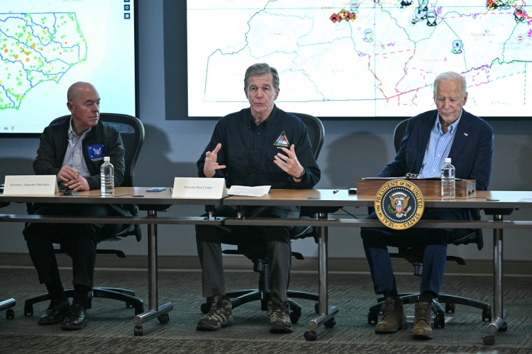 North Carolina governor Roy Cooper (C) speaks as US President Joe Biden (R) and US Secretary of Homeland Security Alejandro Mayorkas (L) listen during an Operational Briefing at Raleigh Emergency Operations Center following the passage of Hurricane Helene, in Raleigh, North Carolina, on October 2, 2024. - The death toll from powerful storm Helene, which battered the southeastern United States, has climbed to at least 155, authorities said on October 1. (Photo by Mandel NGAN / AFP)