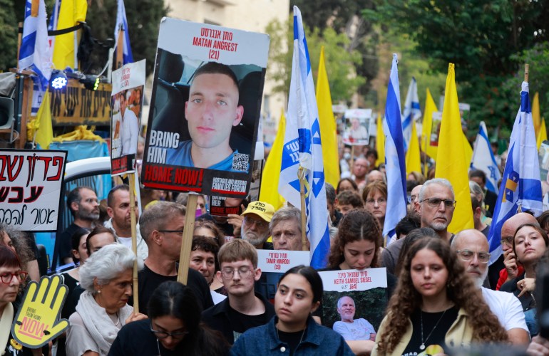 A photo of captive soldier Matan Angrest is seen as relatives and supporters of Israeli hostages taken by Palestinian militants on the October 7 Hamas attack and held in Gaza, hold images of their loved ones during a protest calling for their release in front of Prime Minister Benjamin Netanyahu residency in Jerusalem on October 7, 2024