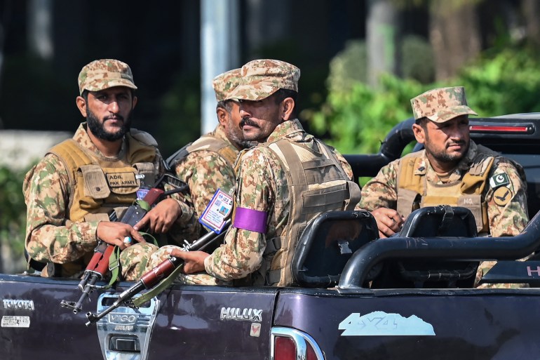 Army personnel sitting on a vehicle patrol at the Red Zone near a venue on the eve of the Shanghai Cooperation Organisation (SCO) summit in Islamabad on October 14, 2024. - Pakistan authorities were preparing on October 13 to shut down the capital ahead of a Shanghai Cooperation Organisation summit, overshadowed by recent militant violence and political unrest.