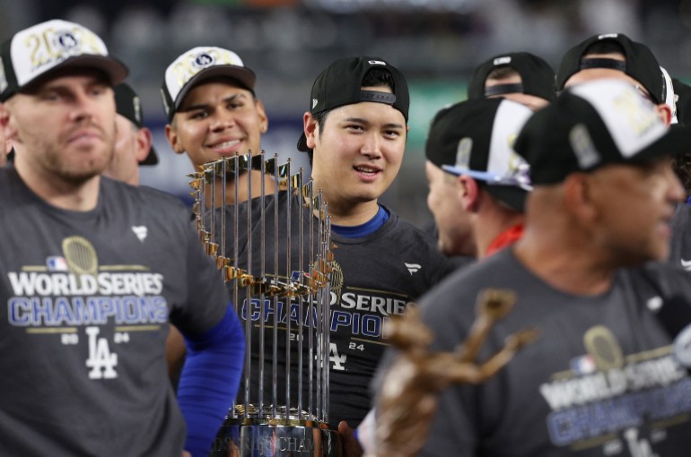 NEW YORK, NEW YORK - OCTOBER 30: Shohei Ohtani #17 of the Los Angeles Dodgers celebrates with the trophy after the Dodgers defeated the New York Yankees 7-6 in game 5 to win the 2024 World Series at Yankee Stadium on October 30, 2024 in the Bronx borough of New York City. Elsa/Getty Images/AFP (Photo by ELSA / GETTY IMAGES NORTH AMERICA / Getty Images via AFP)