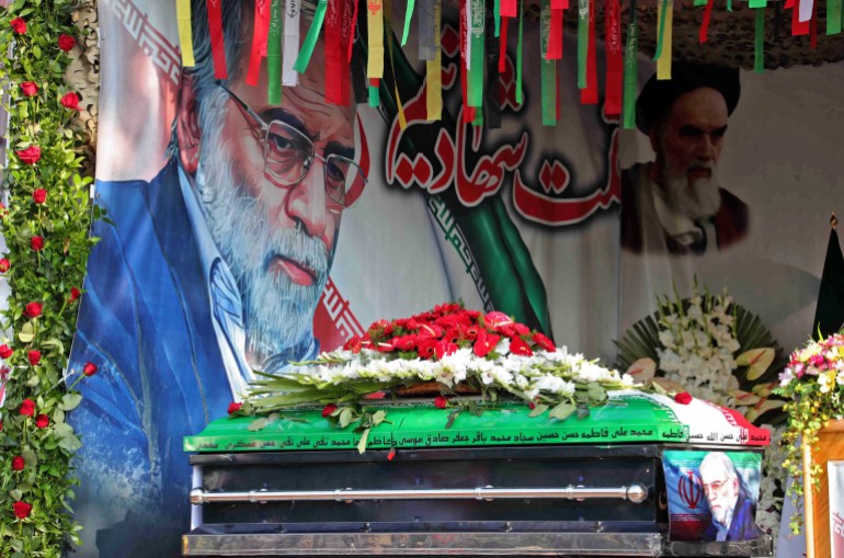 A handout picture provided by Iran's Defence Ministry on November 30, 2020 shows the coffin of slain top nuclear scientist Mohsen Fakhrizadeh in front of a large display depicting Fakhrizadeh next to Iran's supreme leader Ayatollah Ali Khamenei during the funeral ceremony in Tehran. - With a funeral worthy of the Islamic Republic's greatest "martyrs", Tehran paid a final tribute to a scientist killed in an assassination blamed on Israel, and promised to continue his work. Fakhrizadeh died on November 27 in a hospital from his wounds after assailants targeted his card and engaged in a gunfight with his bodyguards outside Tehran, according to Iran's defence ministry. (Photo by - / IRANIAN DEFENCE MINISTRY / AFP) / == RESTRICTED TO EDITORIAL USE - MANDATORY CREDIT "AFP PHOTO / HO /IRANIAN DEFENCE MINISTRY" - NO MARKETING NO ADVERTISING CAMPAIGNS - DISTRIBUTED AS A SERVICE TO CLIENTS ==