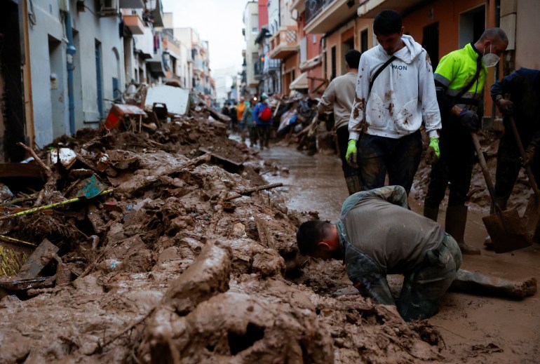 People help to clean, following heavy rains that caused floods,