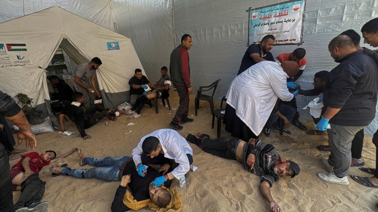 Palestinian assist casualties following an Israeli strike, amid the Israel-Hamas conflict, in Beit Lahiya in the northern Gaza Strip October 30, 2024.