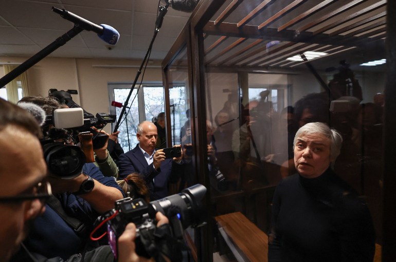 Nadezhda Buyanova, a 68-year-old paediatrician denounced by a patient's mother for an alleged unpatriotic statement and accused of blaming Russia's armed forces for a military conflict against Ukraine, stands inside an enclosure for defendants during a court hearing in Moscow, Russia November 12, 2024. REUTERS/Evgenia Novozhenina