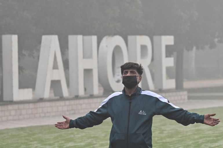 A man exercises in a park amid heavy smoggy conditions in Lahore