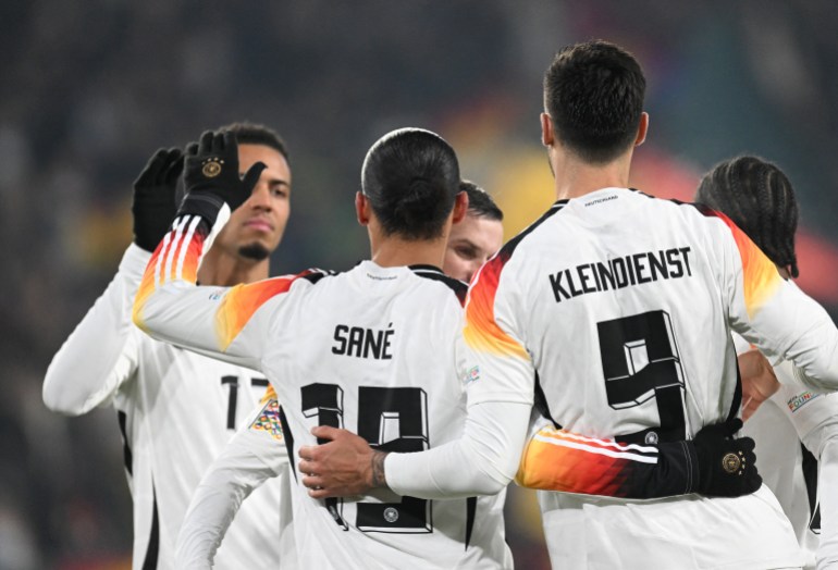 Germany's midfielder #19 Leroy Sane (2L) celebrates with teammates scoring his team's sixth goal during the UEFA Nations League football match between Germany and Bosnia and Herzegovina, in Freiburg, on November 16, 2024. (Photo by THOMAS KIENZLE / AFP)