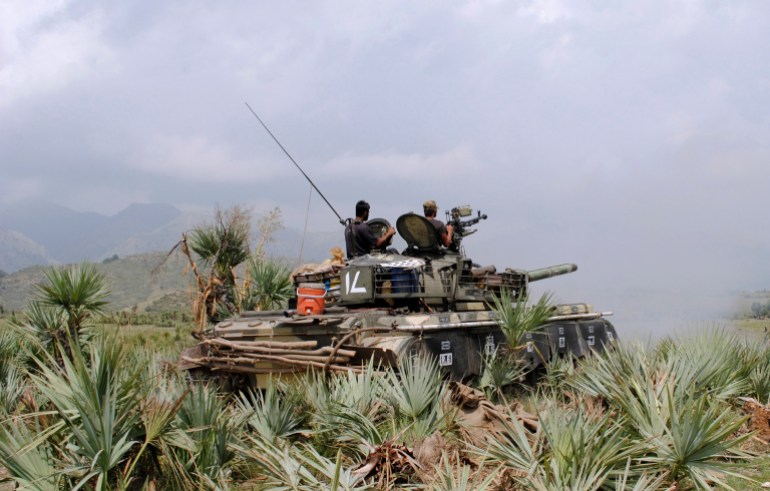 Pakistani army soldiers fire an artillery shell toward a target at a forward base during a military operation against militants in Pakistan's Khurram tribal region, Sunday, July 10, 2011. A military operation in Kurram tribal region has been launched to clear the area of terrorists involved various kinds of terrorist activities, including kidnapping and killing of locals, suicide attacks and blocking the road connecting Lower with upper Kurram, Pakistani army spokesman Maj. Gen. Athar Abbas said. (AP Photo/Mohammad Zubair)