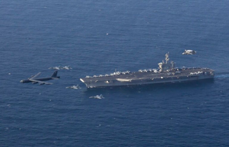 FILE - In this June 1, 2019 file photo, the USS Abraham Lincoln carrier and a U.S. Air Force B-52H Stratofortress, conduct joint exercises in the U.S. Central Command area of responsibility in Arabian sea. The Abraham Lincoln that the White House ordered to the Mideast over a perceived threat from Iran remains outside of the Persian Gulf amid efforts to de-escalate tensions between Tehran and Washington. (Mass Communication Specialist 1st Class Brian M. Wilbur/U.S. Navy via AP, File)