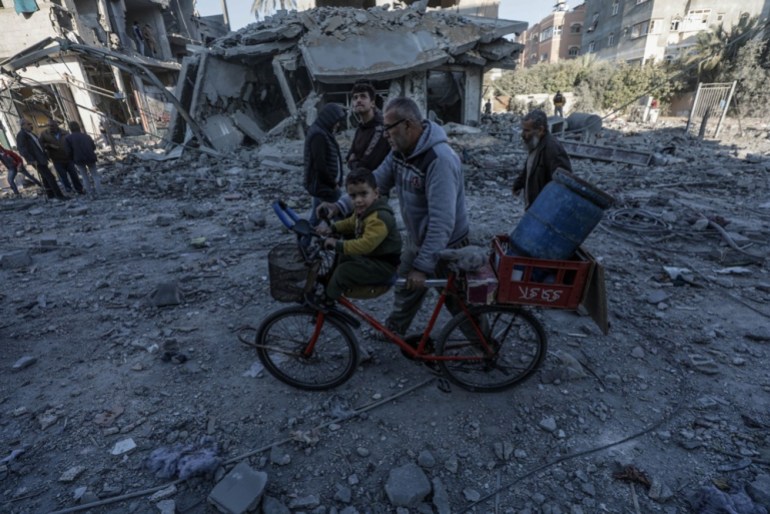 epa11751062 Palestinians walk near the rubble of a destroyed building following an Israeli airstrike in Al Nuseirat refugee camp, central Gaza Strip, 01 December 2024. According to the Palestinian Ministry of Health in Gaza, at least 15 Palestinians were killed following an Israeli airstrike in Al Nuseirat refugee camp overnight. More than 44,300 Palestinians and over 1,400 Israelis have been killed, according to the Palestinian Health Ministry and the Israeli Army, since Hamas militants launched an attack against Israel from the Gaza Strip on 07 October 2023, and the Israeli operations in Gaza and the West Bank which followed it. EPA-EFE/MOHAMMED SABER