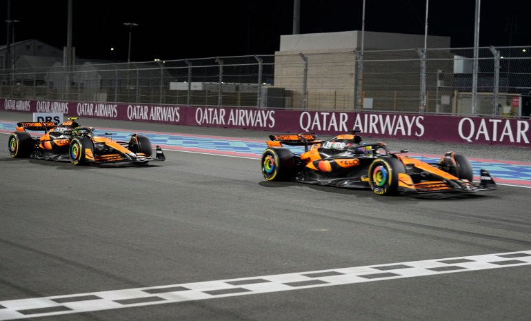 Formula One F1 - Qatar Grand Prix - Lusail International Circuit, Lusail, Qatar - November 30, 2024 McLaren's Oscar Piastri crosses the line to win the sprint race ahead of second place McLaren's Lando Norris Pool via REUTERS/Altaf Qadri