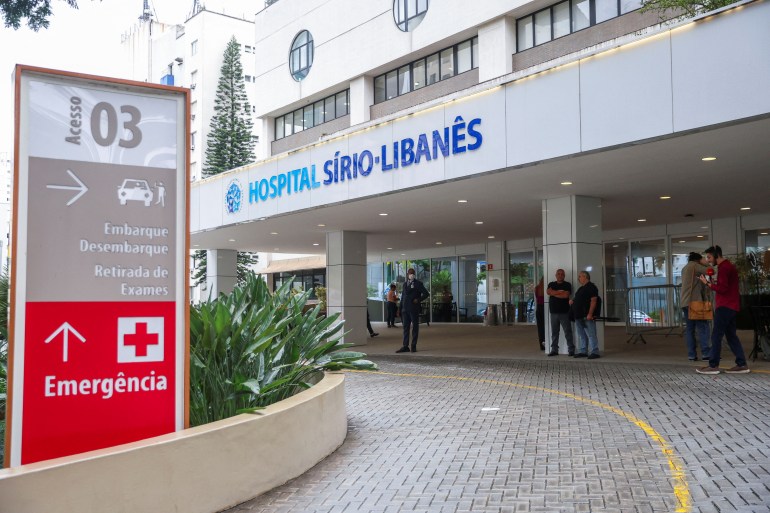 People stand outside Sirio-Libanes Hospital in Sao Paulo, Brazil