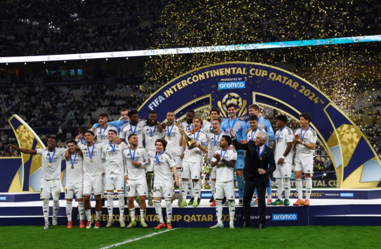 Soccer Football - Intercontinental Cup - Final - Real Madrid v Pachuca - Lusail Stadium, Lusail, Qatar - December 18, 2024 Real Madrid's Luka Modric lifts the trophy as he celebrates with teammates after winning the Intercontinental Cup REUTERS/Rula Rouhana