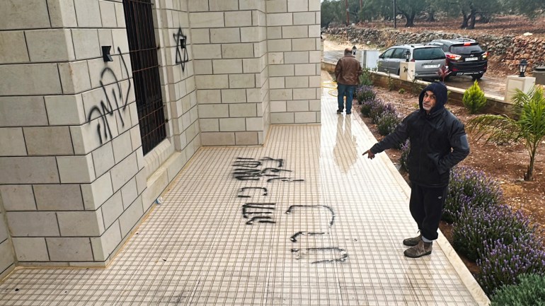 A person checks a damaged mosque, which according to Palestinians was burned by Israeli settlers, near Salfit in the Israeli-occupied West Bank December 20,2024. RETUERS/Stringer