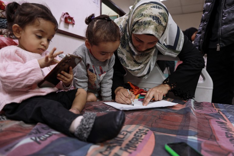 Shefa plays with Hanan and Misk in the hospital in Deir el-Balah, Gaza, after Israel's bombs destroyed their legs