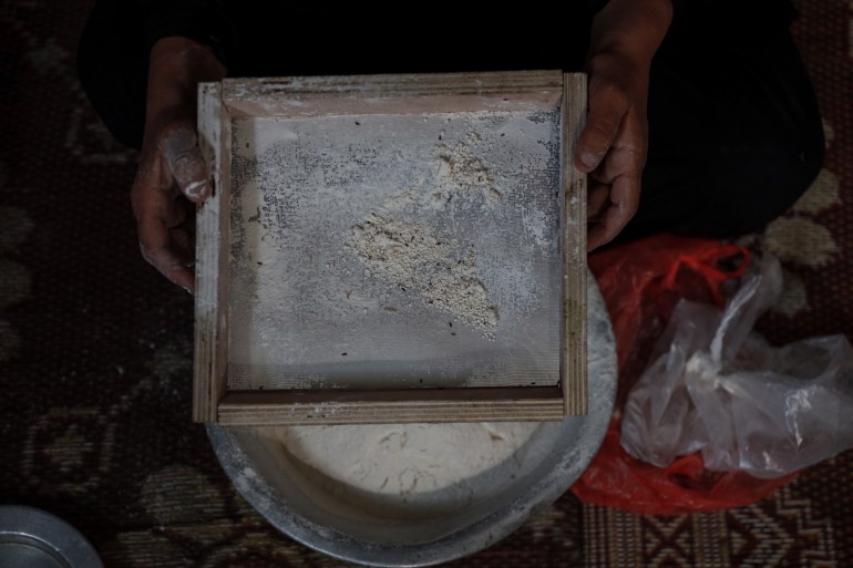 Many families in central and southern Gaza resort to using spoiled flour if they have it [Abdelhakim Abu Riash/Al Jazeera]