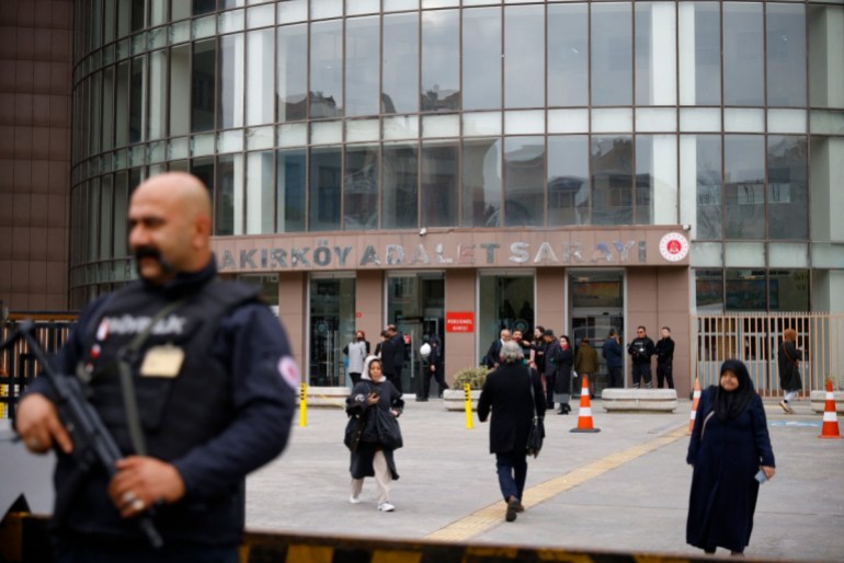 A security member stands guard in front of the Bakirkoy courthouse, on the opening day of Turkey's "newborn gang trafficking" case trial, in Istanbul, on November 18, 2024. - The court suspects a network of private hospital owners, doctors, emergency call centre operators and ambulance drivers of having placed and kept perfectly healthy newborns in the neonatal intensive care units of certain establishments for no reason at all, sometimes for weeks at a time, claiming false medical reasons to grieving parents. Ten infants have died in private hospitals as a result of the vast social security fraud. (Photo by KEMAL ASLAN / AFP)