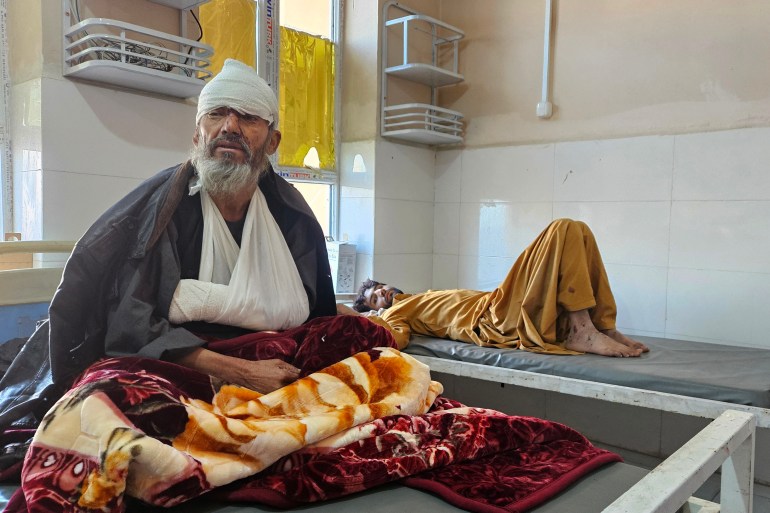 Afghan injured passengers receive treatment at a hospital after a bus accident