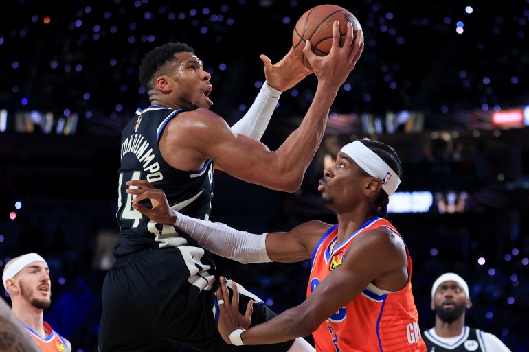 Giannis Antetokounmpo playing basketball.