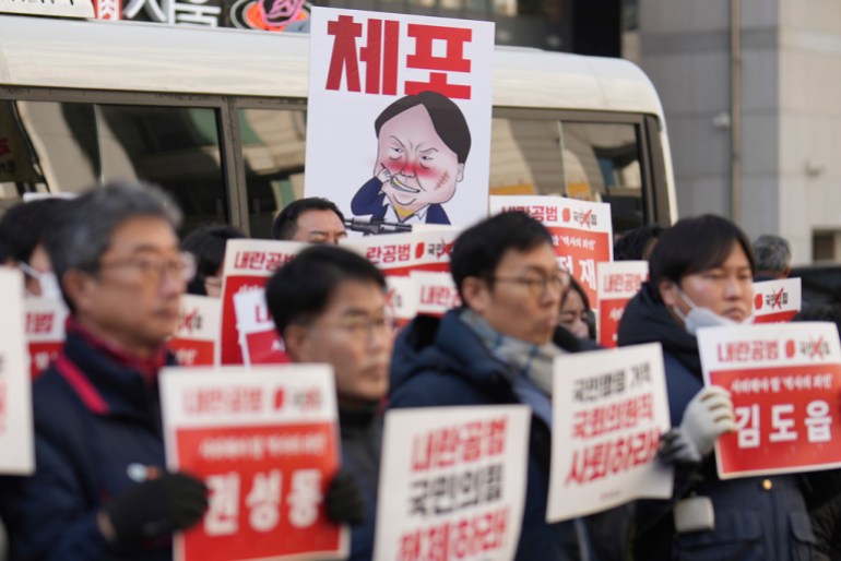 A caricature depicting South Korean President Yoon Suk Yeol is seen in front of the ruling People Power Party's head office in Seoul, South Korea, Monday, Dec. 9, 2024. (AP Photo/Lee Jin-man)