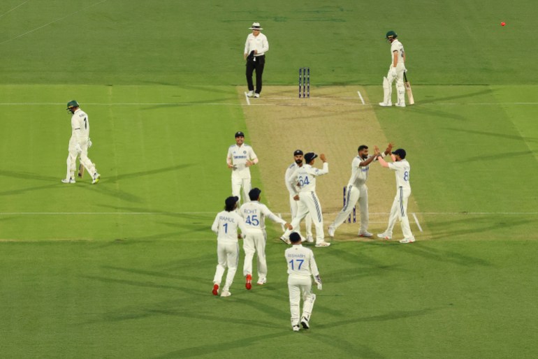 ADELAIDE, AUSTRALIA - DECEMBER 06: Jasprit Bumrah of India celebrates with teammate Nitish Kumar Reddy of India after dismissing Usman Khawaja of Australia as he leaves the field during day one of the Men's Test Match series between Australia and India at Adelaide Oval on December 06, 2024 in Adelaide, Australia. (Photo by Robert Cianflone/Getty Images)