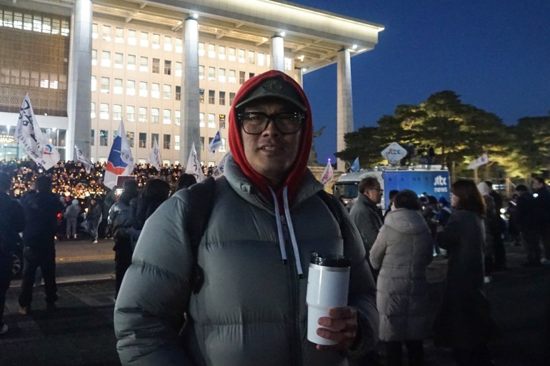 Min Jun-shik, 43, joined the demonstration after finishing work on Wednesday evening