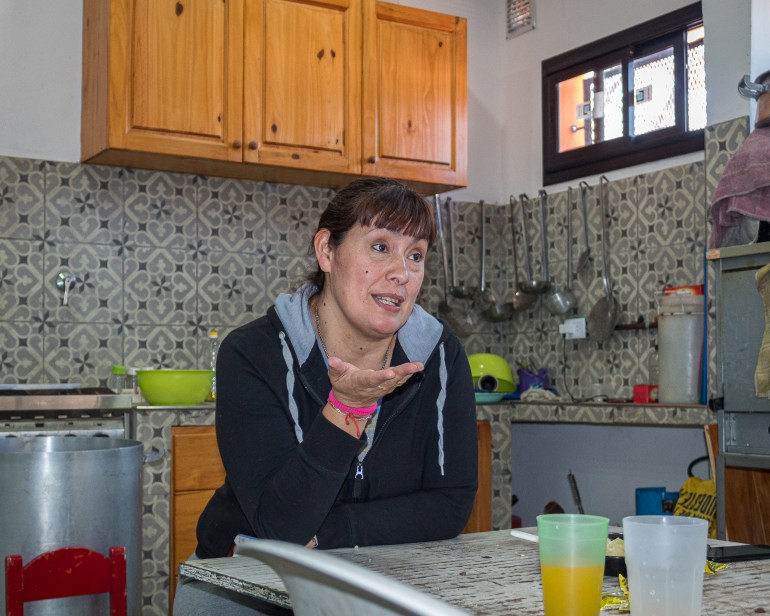 Fernanda Miño sits and talks over her kitchen table in La Cava, Buenos Aires